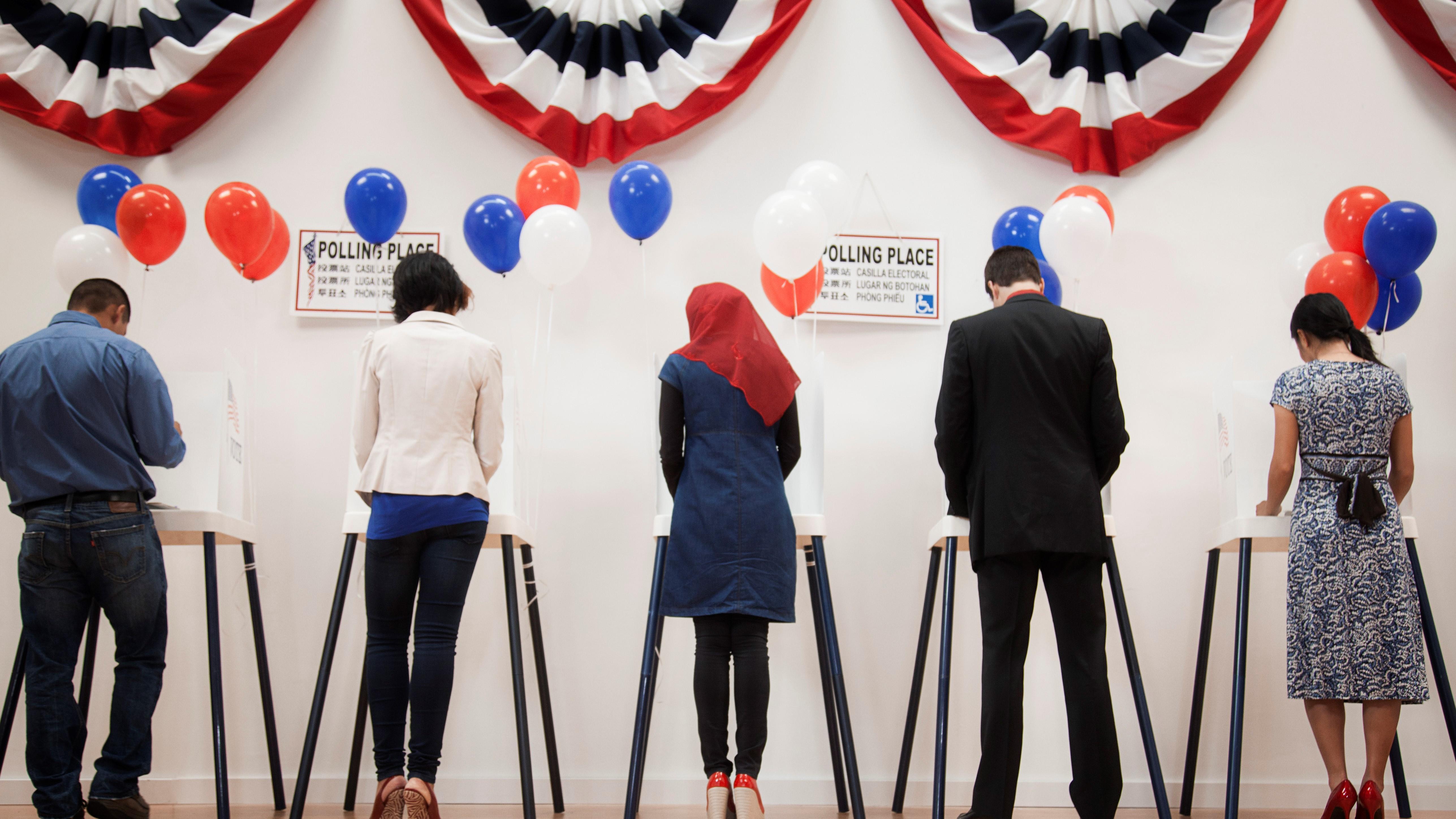 Five people at the voting boxes